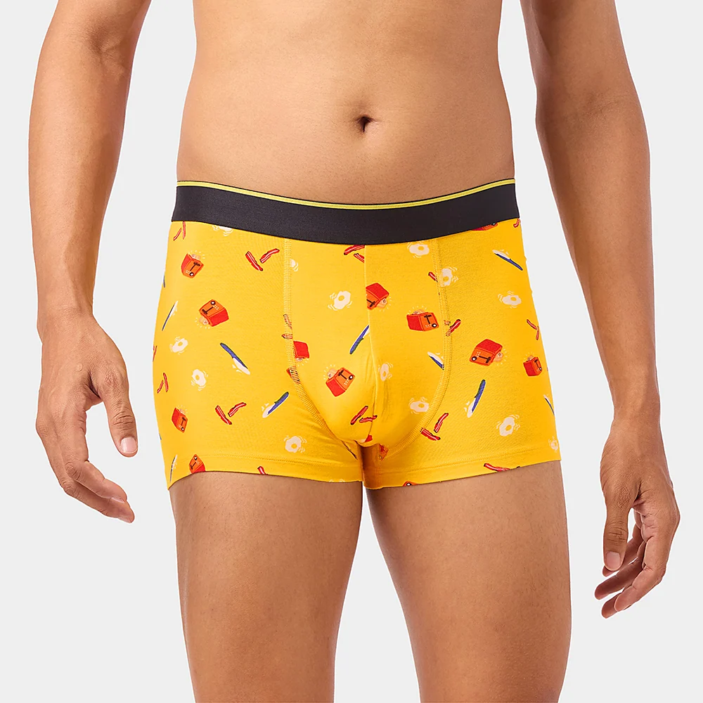 Close-up photograph of yellow Brekkie breakfast-print trunks