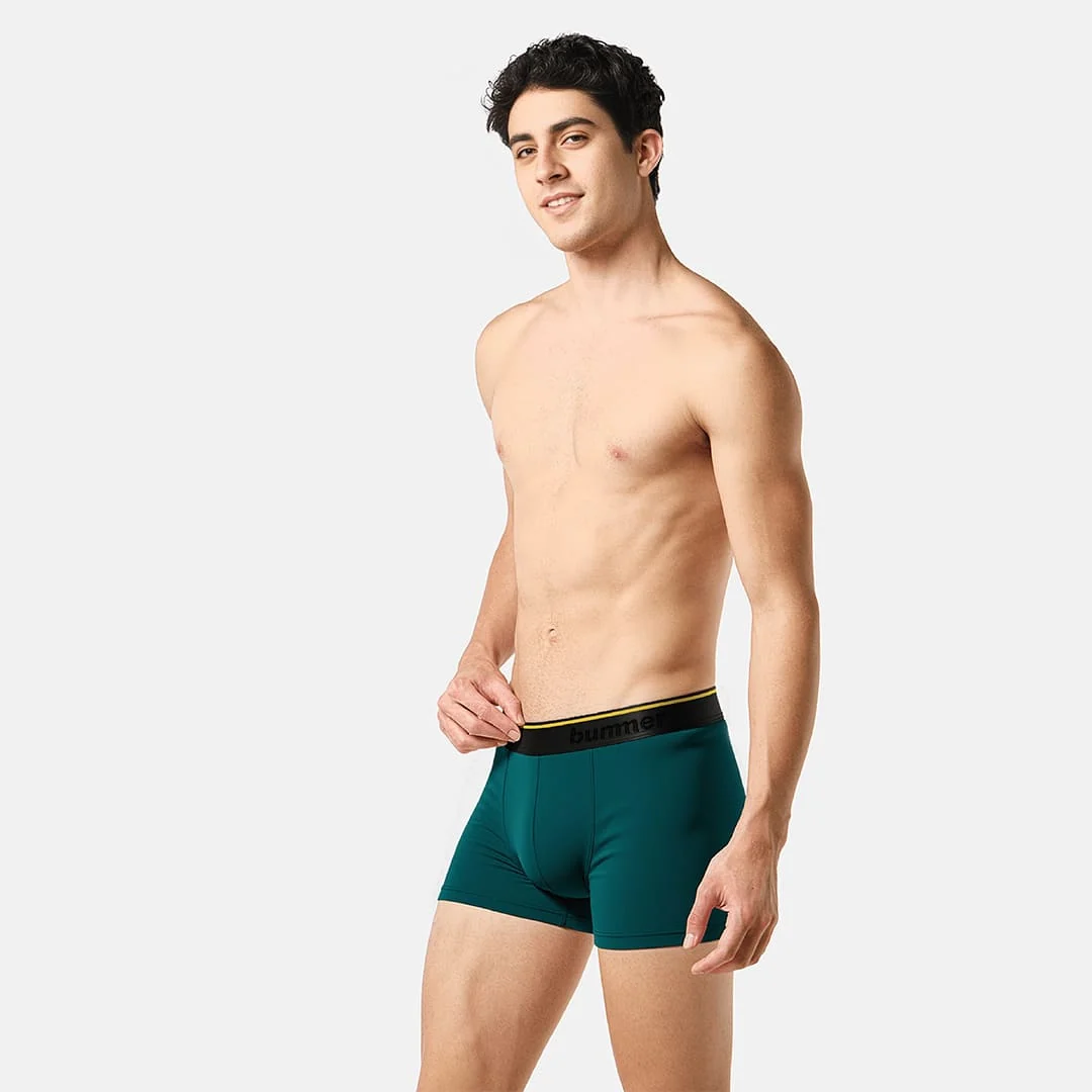 Model wearing teal Marina MicroModal trunks by Bummer